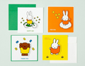 Four Miffy-themed greeting cards with matching envelopes arranged on a pale green background. The cards feature colorful illustrations of Miffy on a bicycle, reading 'HAPPY DAY' and 'FOR YOU', a teddy bear holding a yellow blanket with 'THANK YOU', and Miffy in orange with small clovers and 'HAVE A GOOD DAY'.