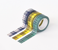 Three rolls of plaid decorative tape in navy blue, yellow, and teal-green, arranged on a clean white background.